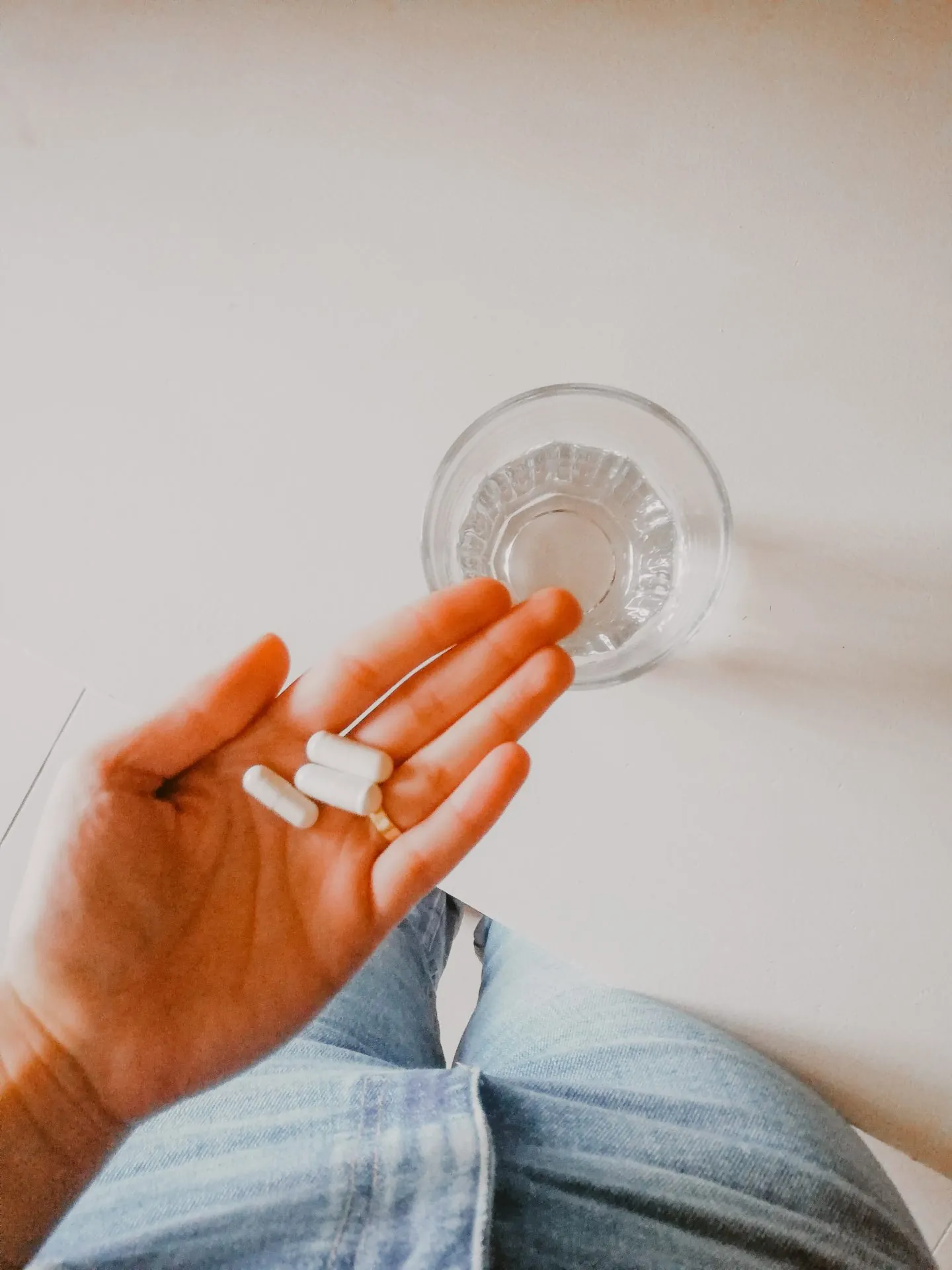 Hand holding nutritional supplement capsules